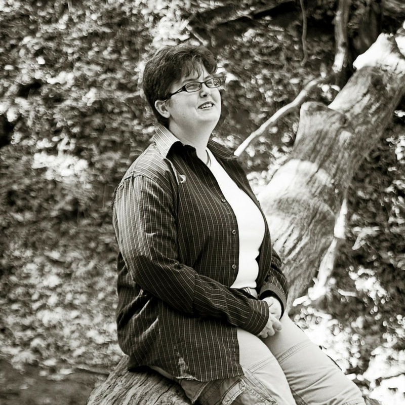 A picture of me using a fallen tree as a natural bench.